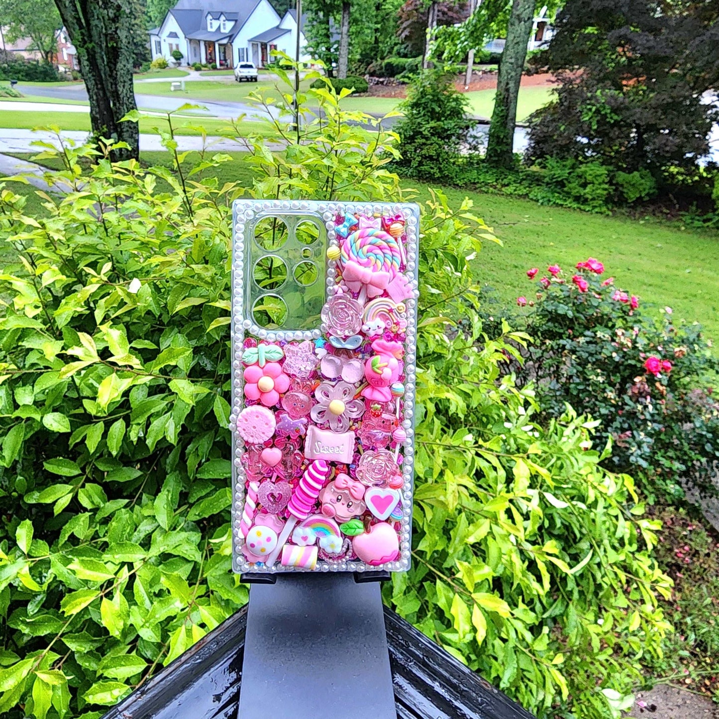 Handmade kawaii pink candy decoden phone case with colorful charms and shimmering details, compatible with iPhone and Samsung.